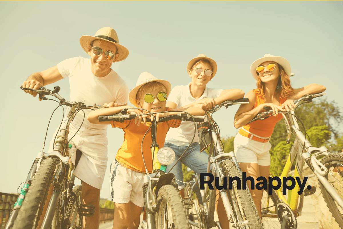 A family on bicycles on a sunny day wearing hats and sunglasses