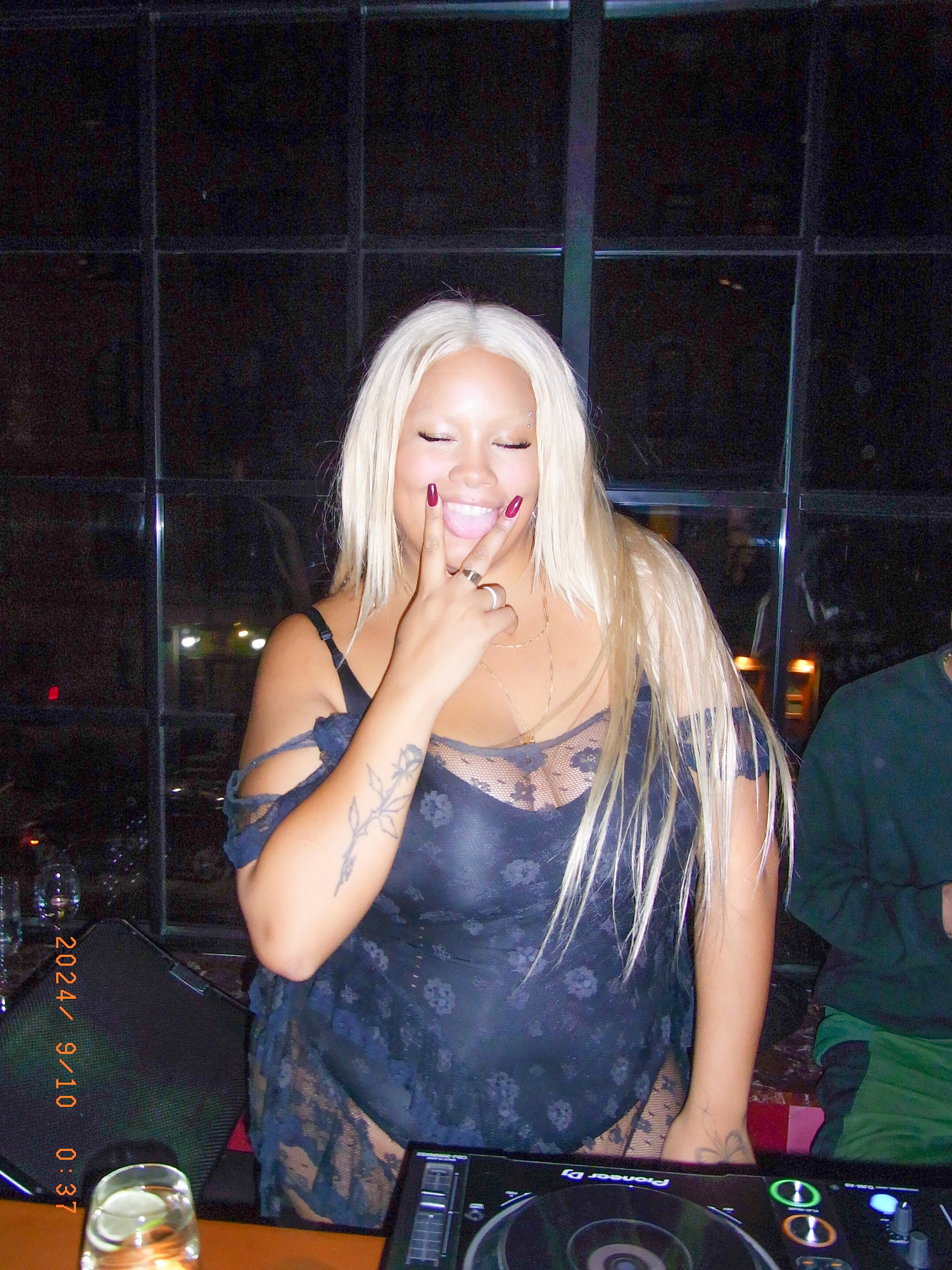 Dancer in black outfit with one leg raised behind