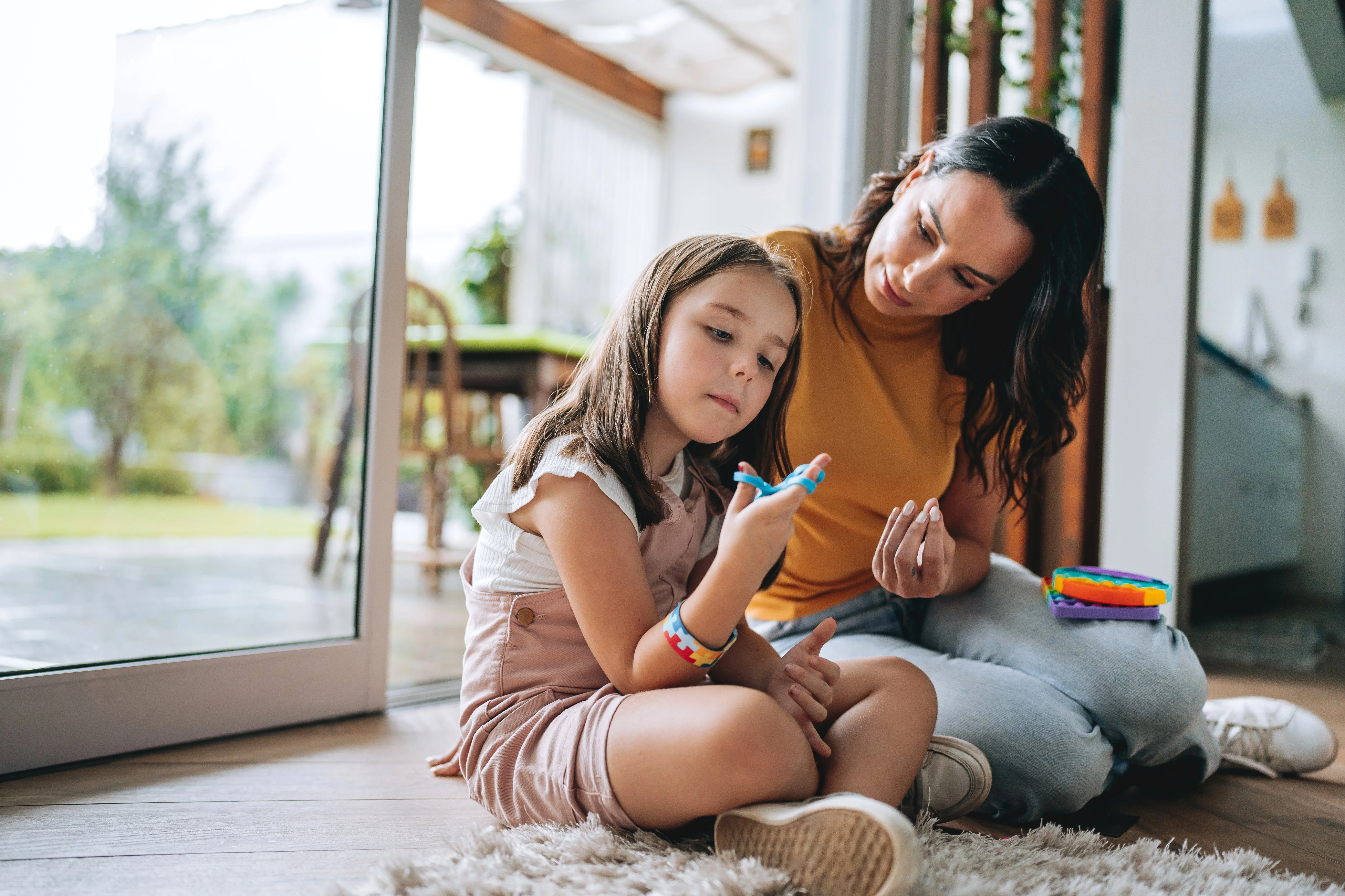 Photo of a mother and her daughter exploring sensory play.