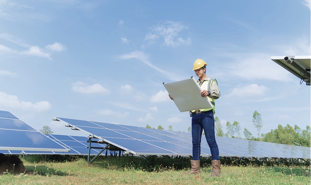 technician checking solar panels