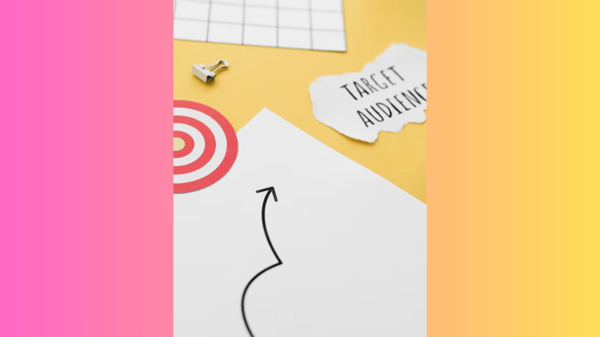 An arrow drawn on paper pointing towards the words target audience. A bullseye lies beside it, symbolising striking the target audience with a possible business strategy.