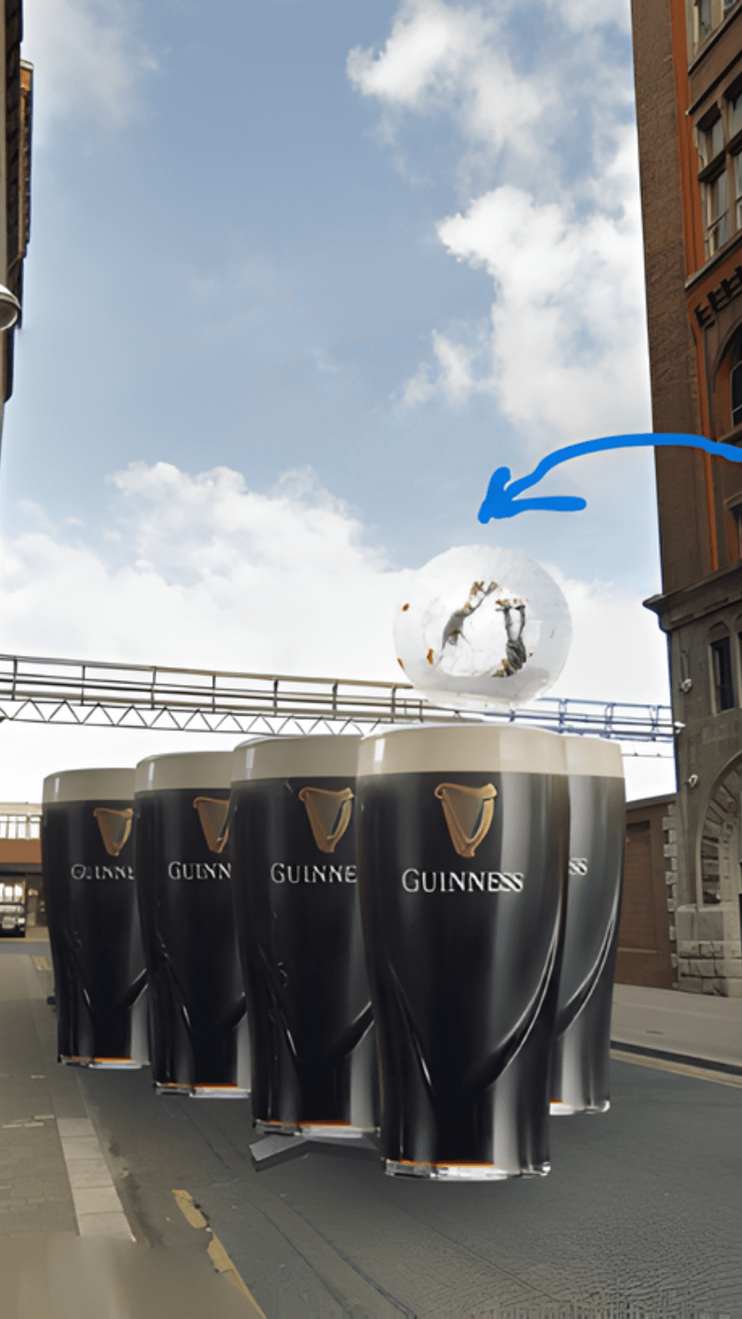 A row of giant, branded Guinness pints fully materialize in the middle of the city street