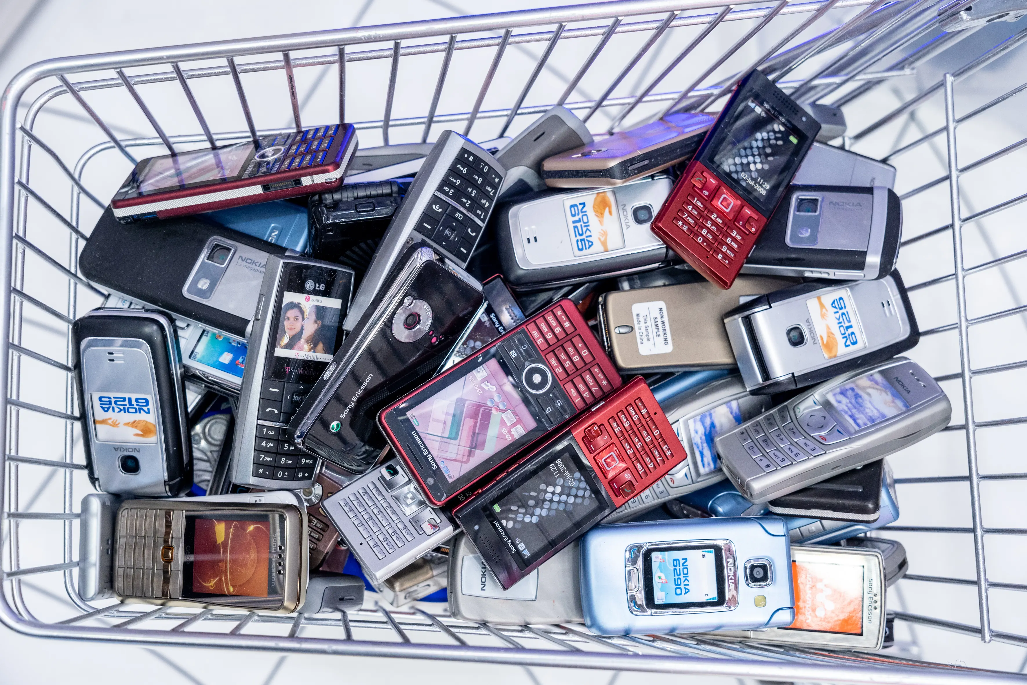 Shopping cart filled with old mobile phones as an installation at the Intermate Social Superstore at OMR.