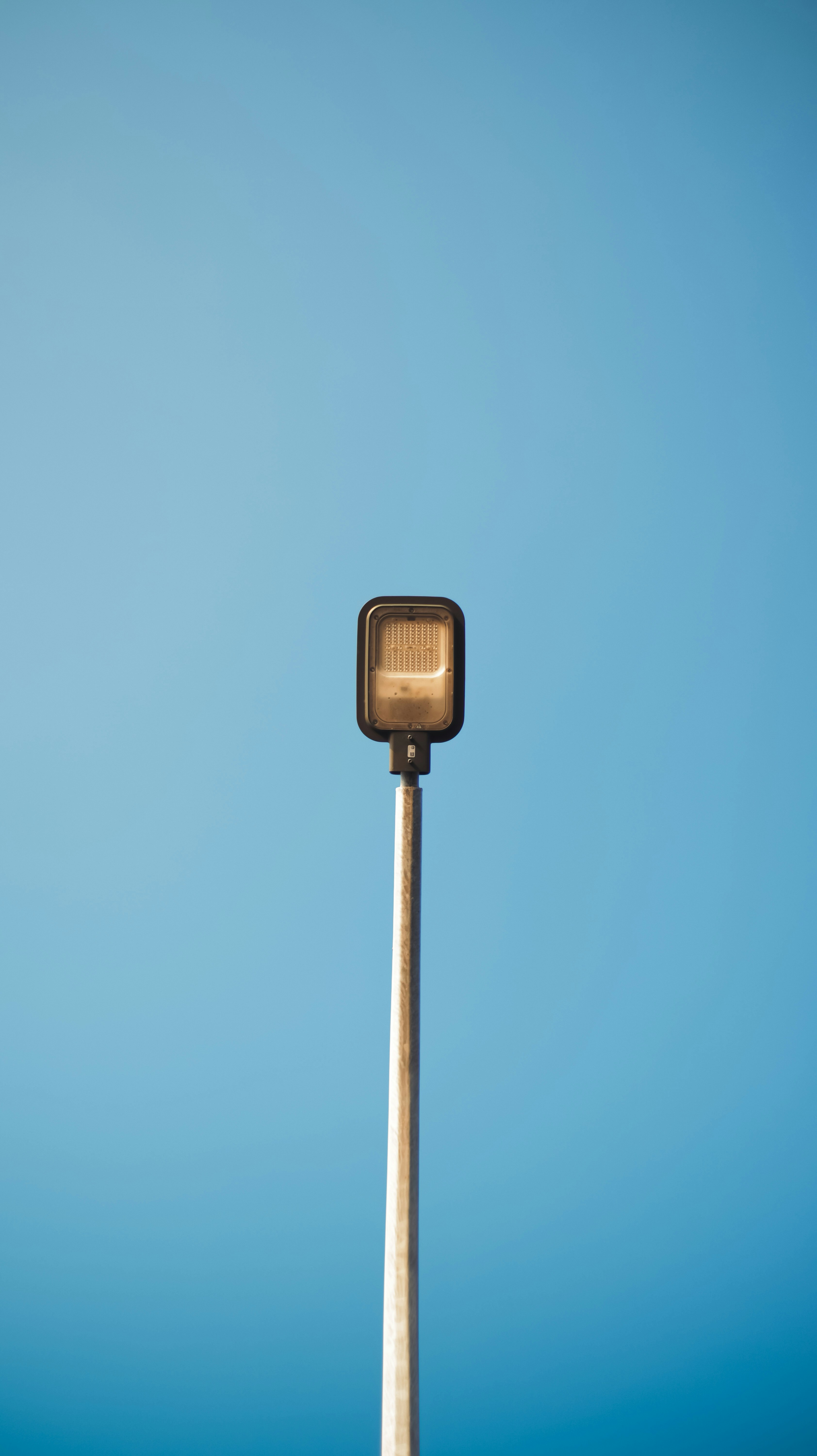 A street light with a blue sky in the background