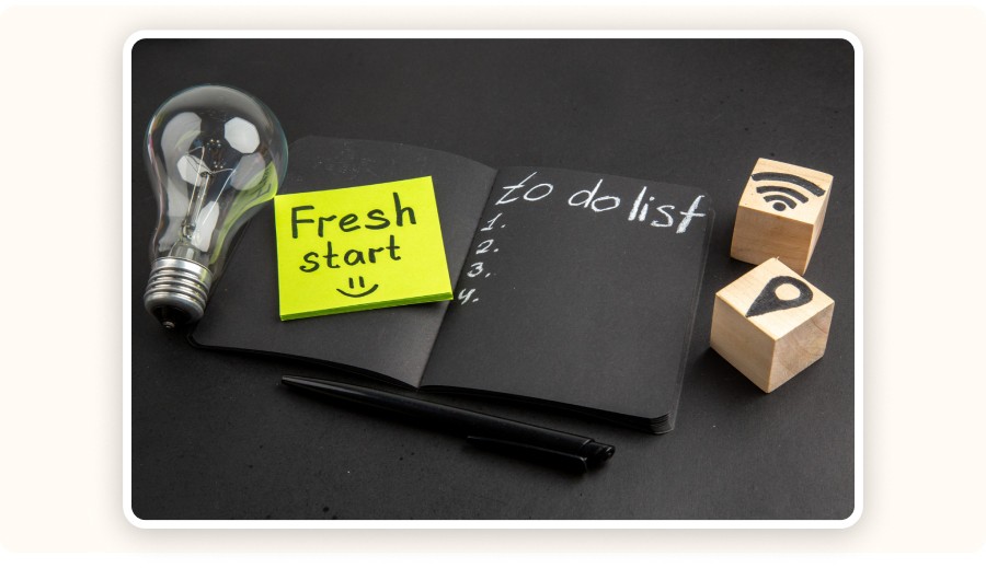 Carnet avec une liste de tâches, post-it “Fresh start”