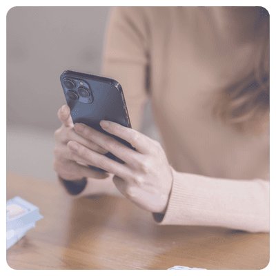 Healthcare staff member using smartphone placing a patient order with another team member