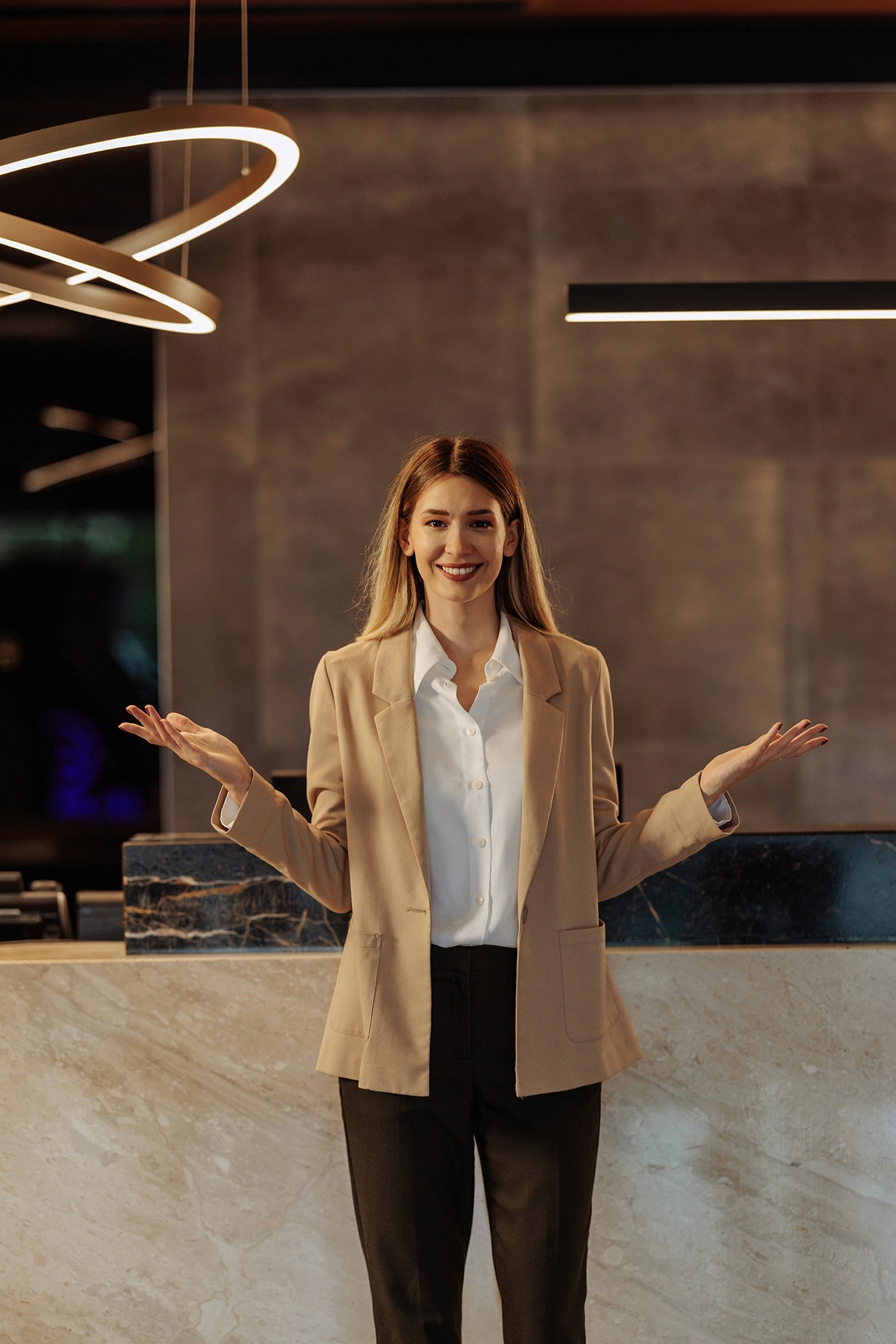 Smiling person with hands raised below shoulder level