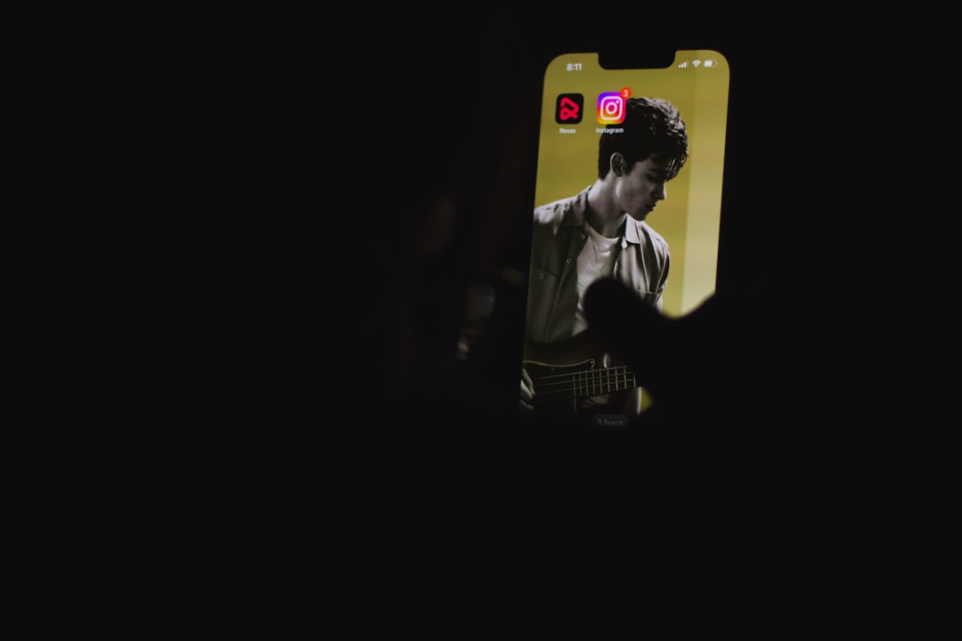 a man playing a guitar in the dark