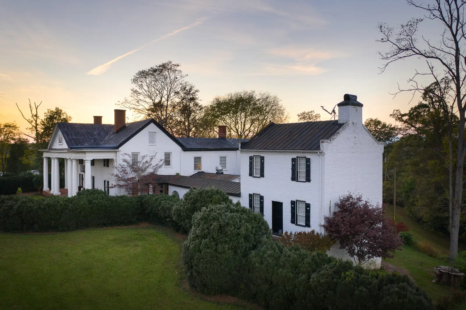 Exterior view of a restaurant on a corner building. A Victorian-era building sign is also visible.