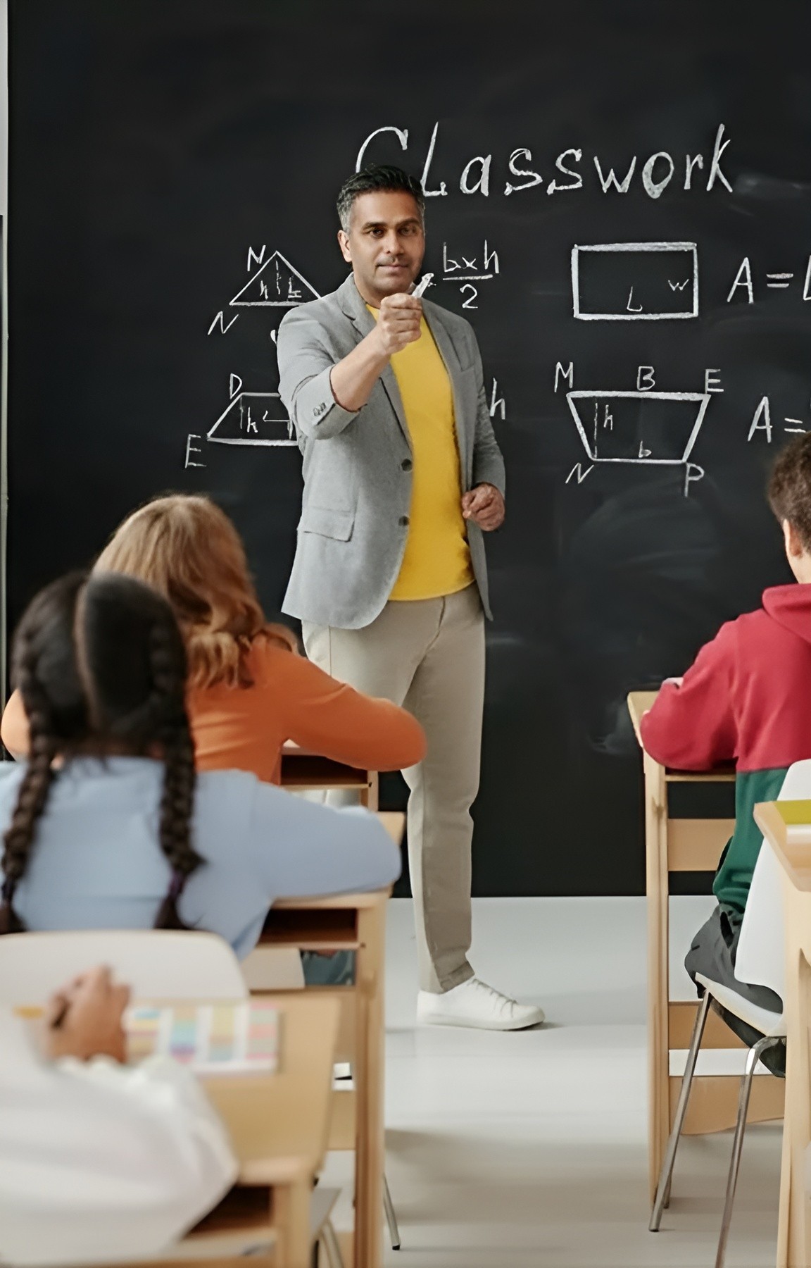 A teacher is explaining a topic, speaking with focus and using gestures to emphasize key points