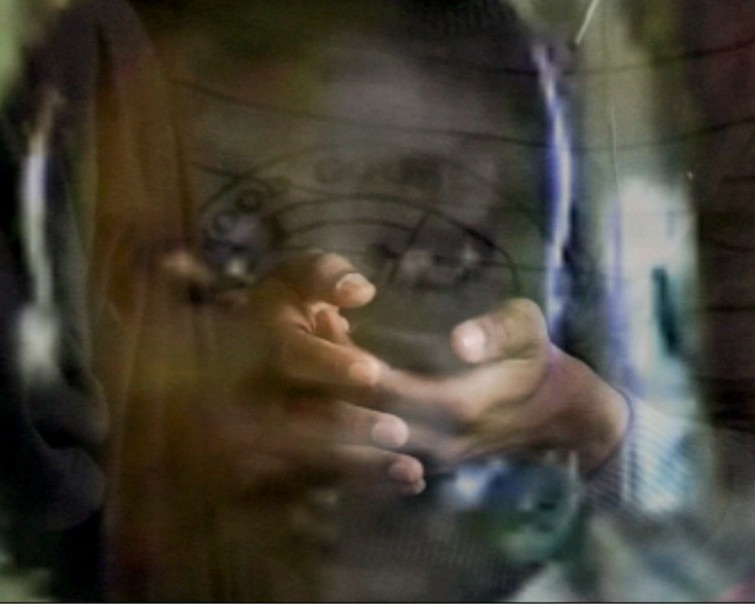 person sitting on grass and using phone