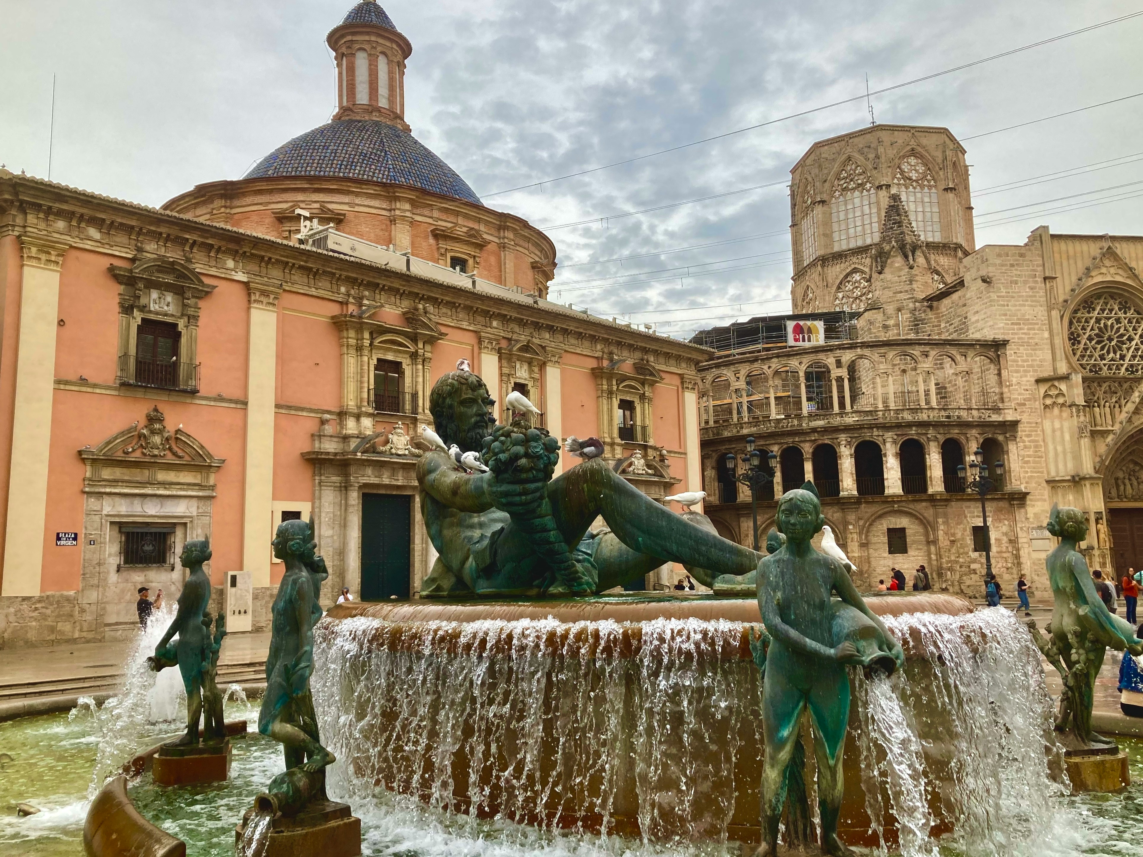 a fountain with a statue of a boy sitting on top of it