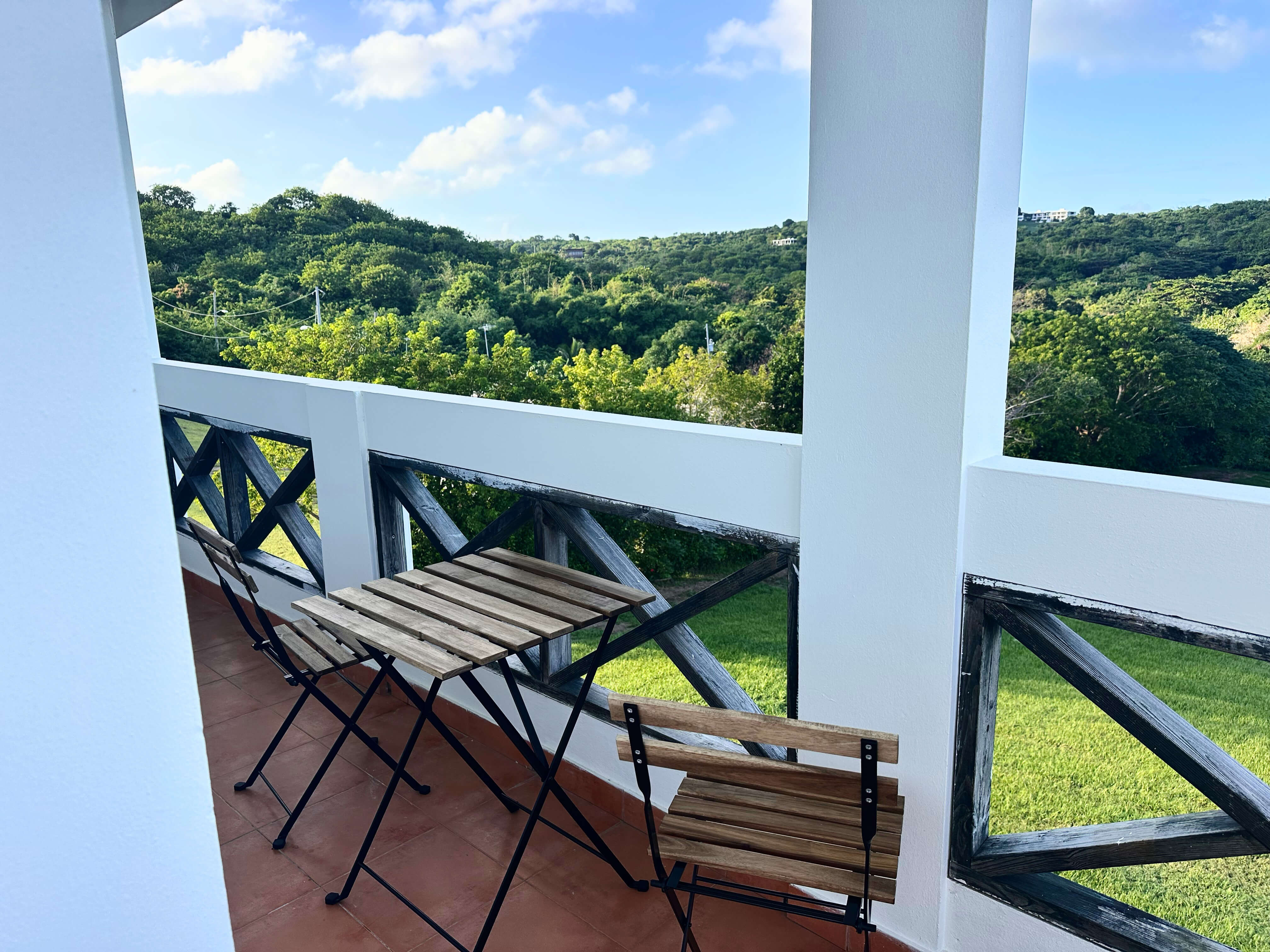 View from the private balcony of Room 9, showcasing the lush tropical landscape.