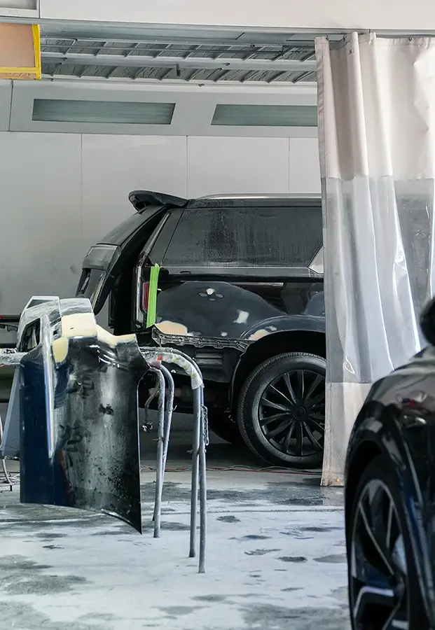 Vehicle undergoing collision repair inside auto body facility in Simi Valley, CA