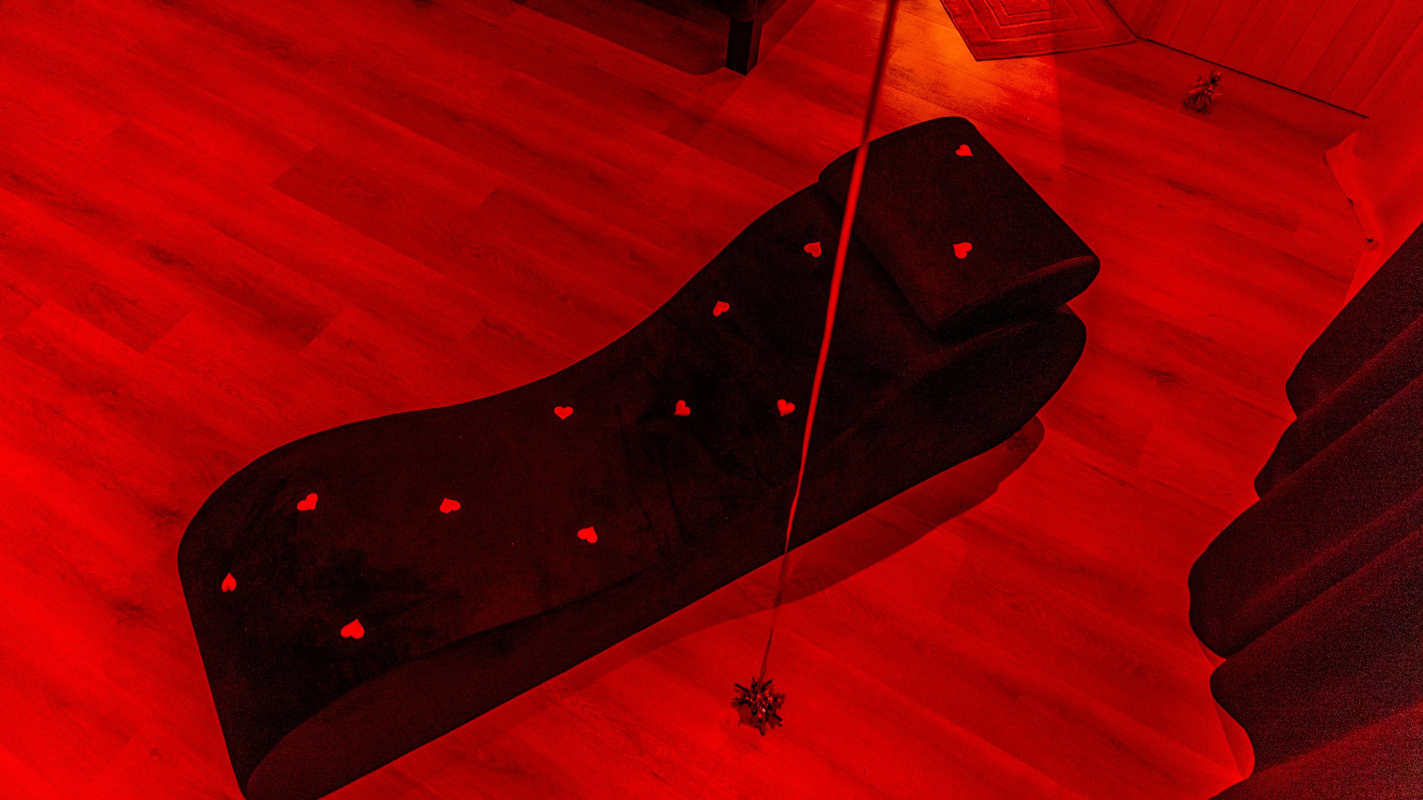 Sunset over calm ocean viewed through oval window.