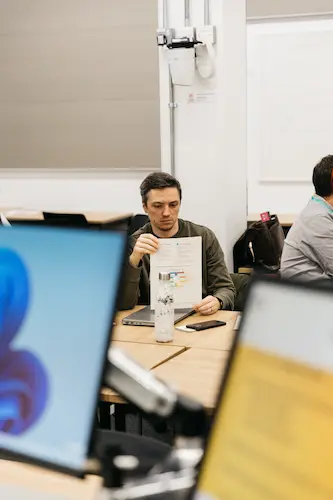 Person working at a desk in an office with computers.