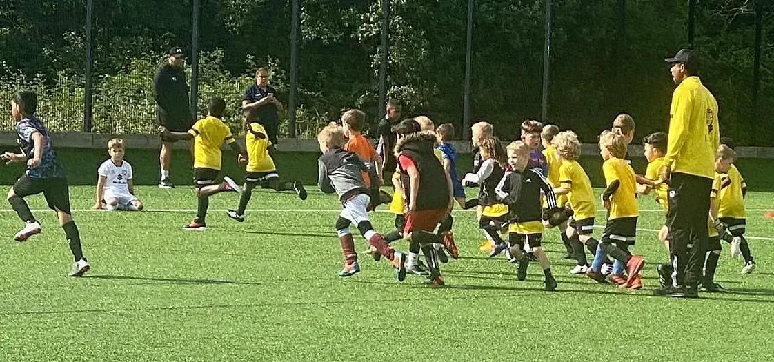 Kids being coached at football