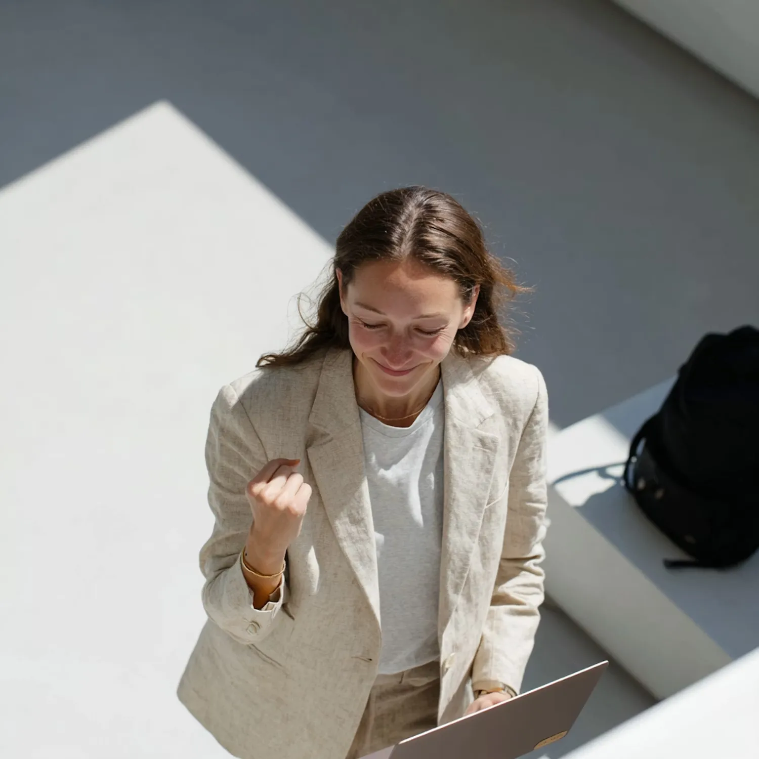 Woman Celebrating with Laptop