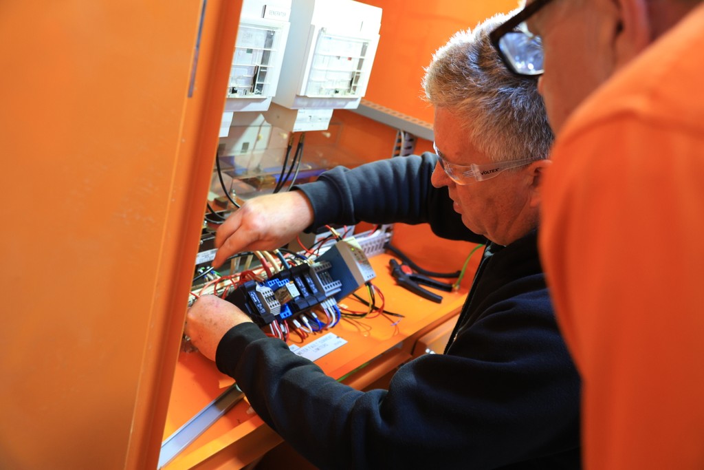 electrician getting tools from van