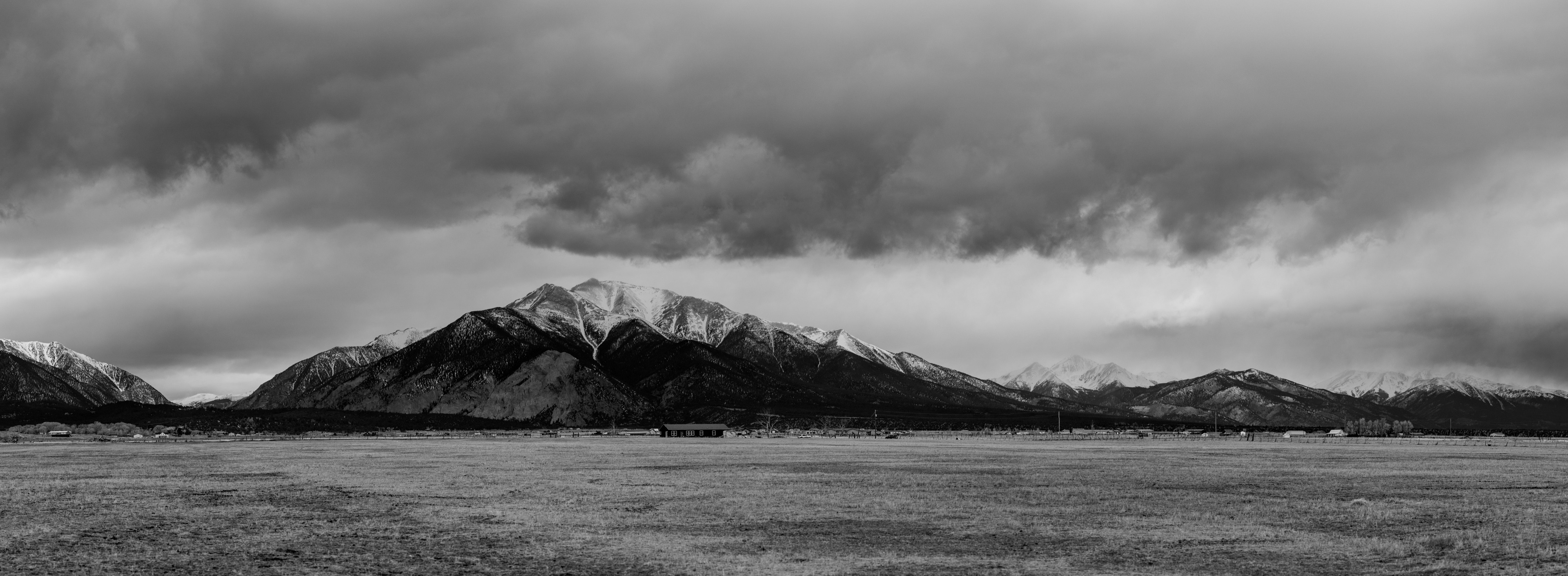 Panoramic landscape photograph of mountains, water, desert, or coast by Lucas Jensen