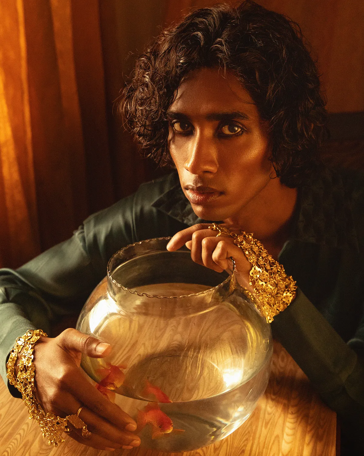 man wearing grey t-shirt standing in front of man sitting on chair