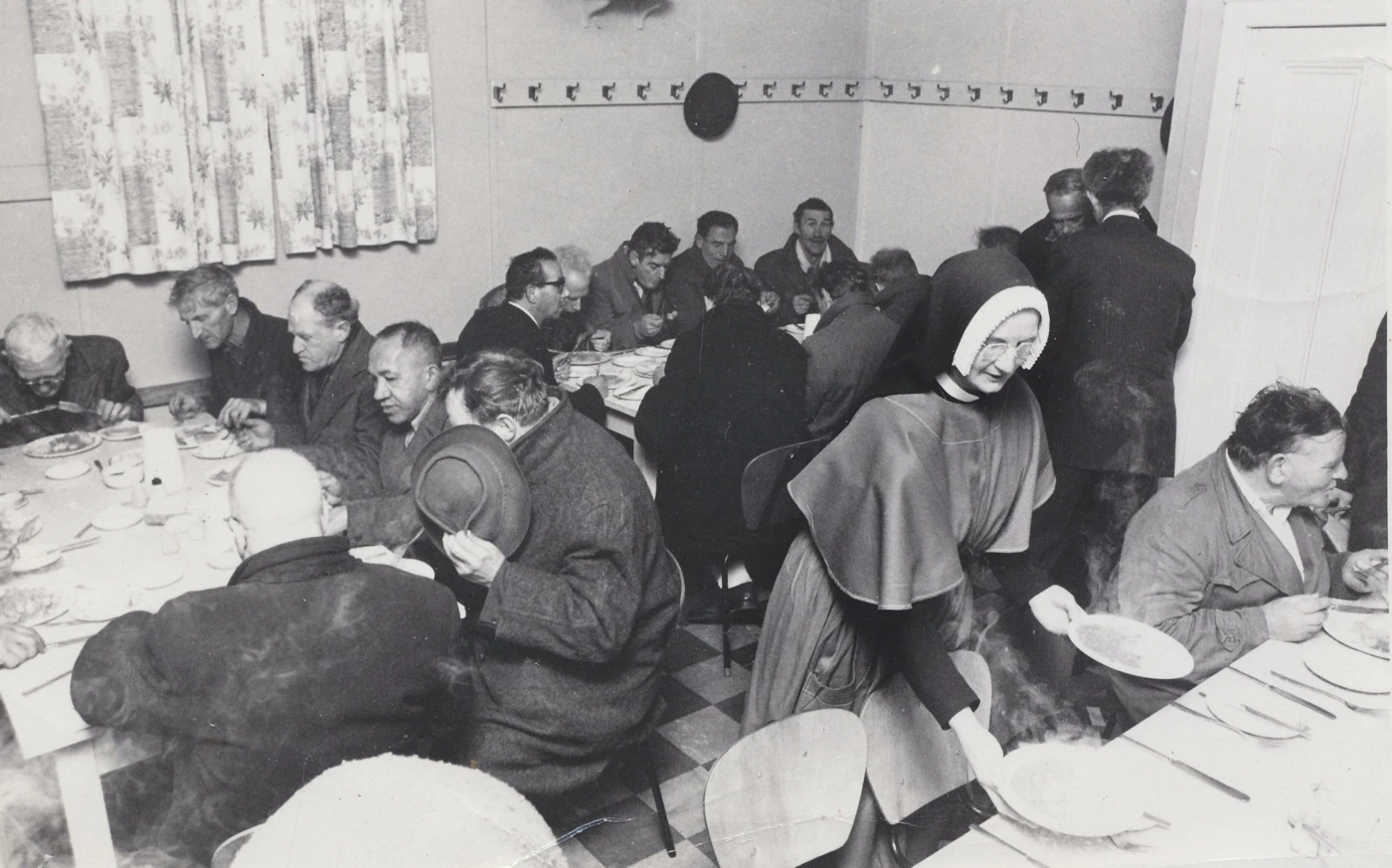 Historic black and white photo of sisters serving at tables