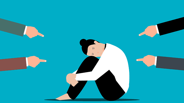 Illustration of a person hugging their knees while four hands point at them from every side