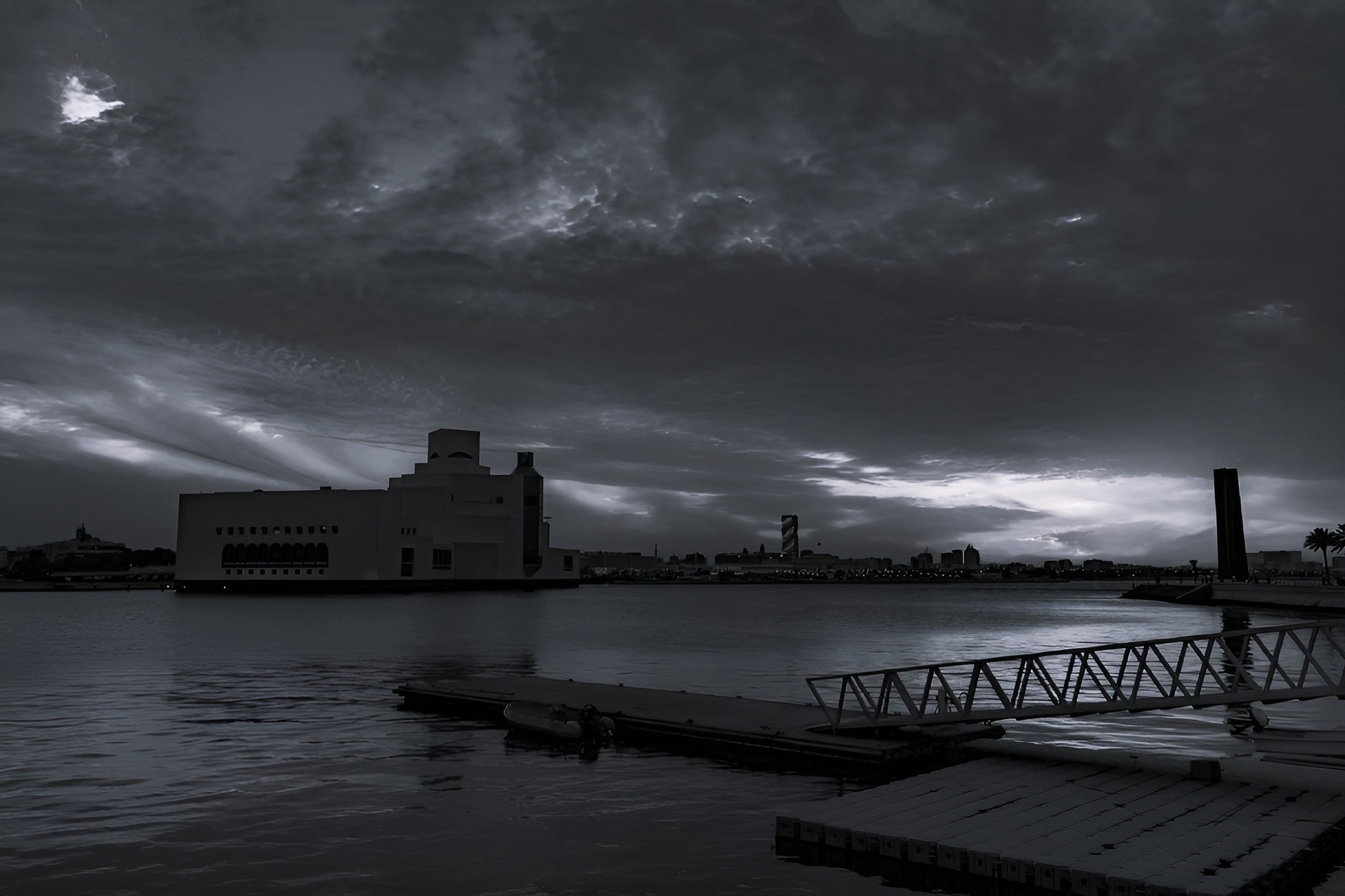 Doha skyline view with the Museum of Islamic Art and Corniche waterfront under a cloudy morning sky