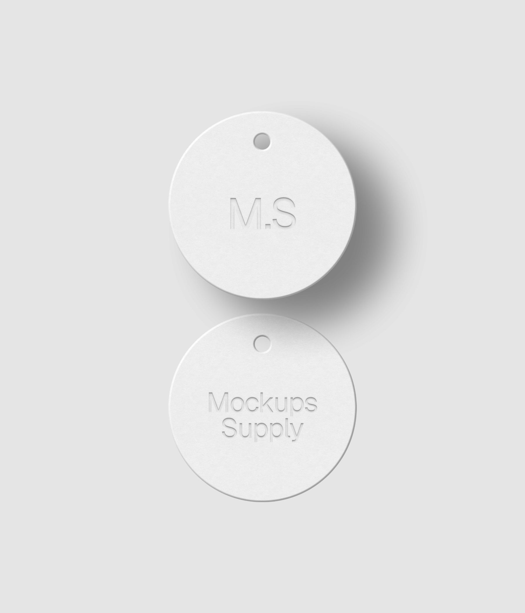 Two white round hang tags with debossed logo effect and realistic shadow on white background mockup PSD template