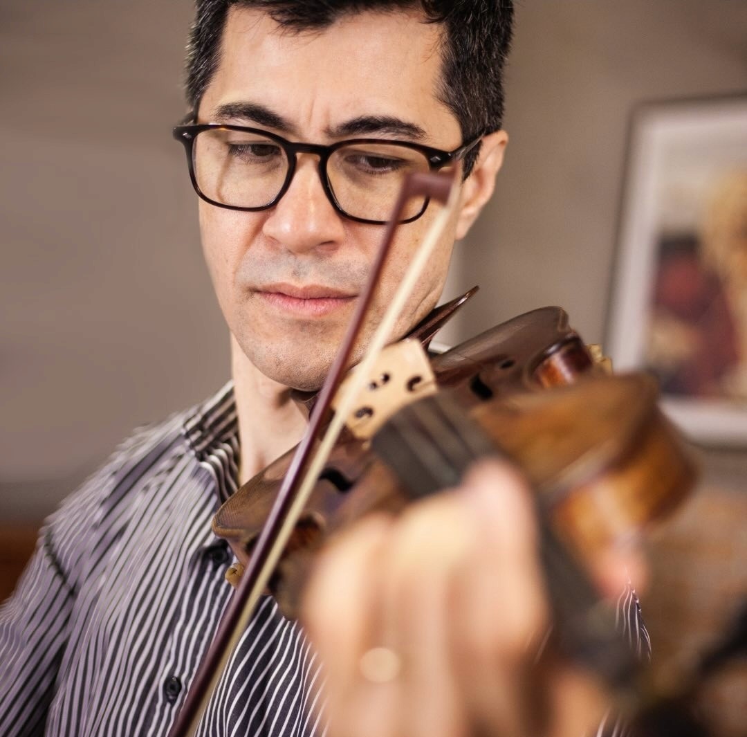 baby playing multicolored xylophone toy