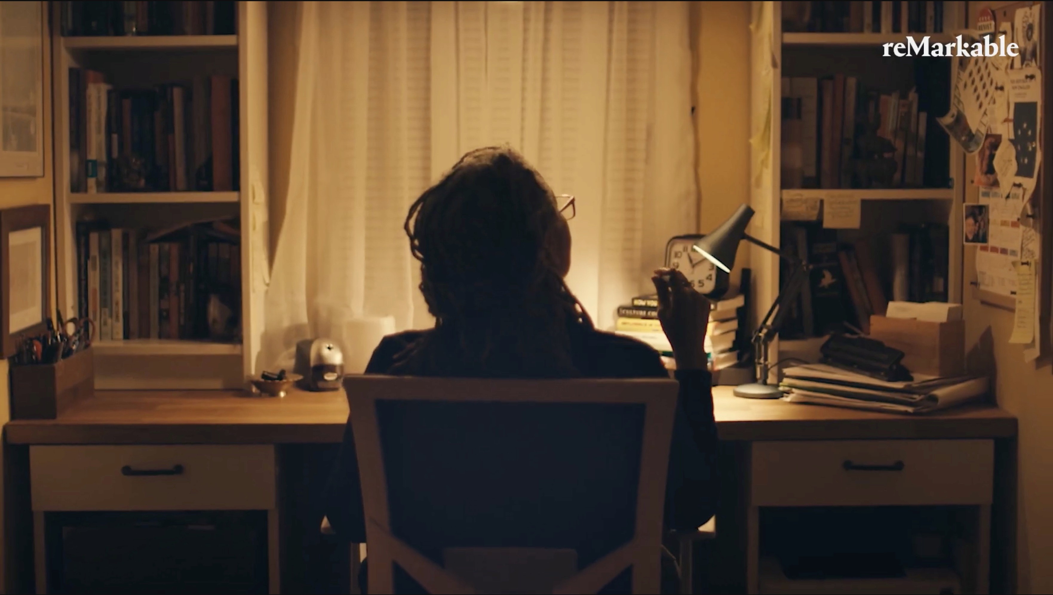 Stephanie Dunson at her desk in her warmly lit home office