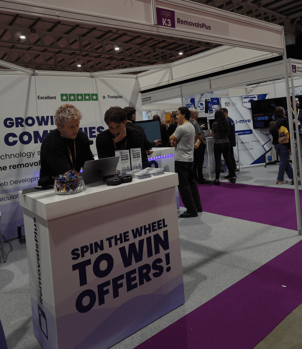 Three people sitting on a couch in a room looking at mobile devices