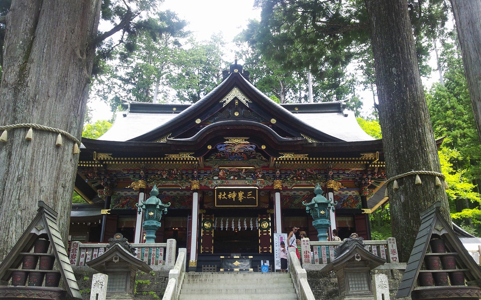 Traditional Japanese shrine surrounded by tall trees, accessible with Seibu Pass.
