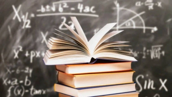 Stack of open and closed books in front of a blackboard filled with math equations, symbolizing academic learning, mathematics education, and study preparation.