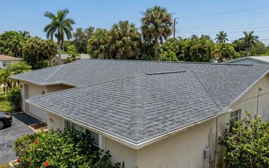 Newly installed residential roof in Fort Lauderdale, Florida with clean, uniform shingles and a fresh, durable finish under bright sunny skies.