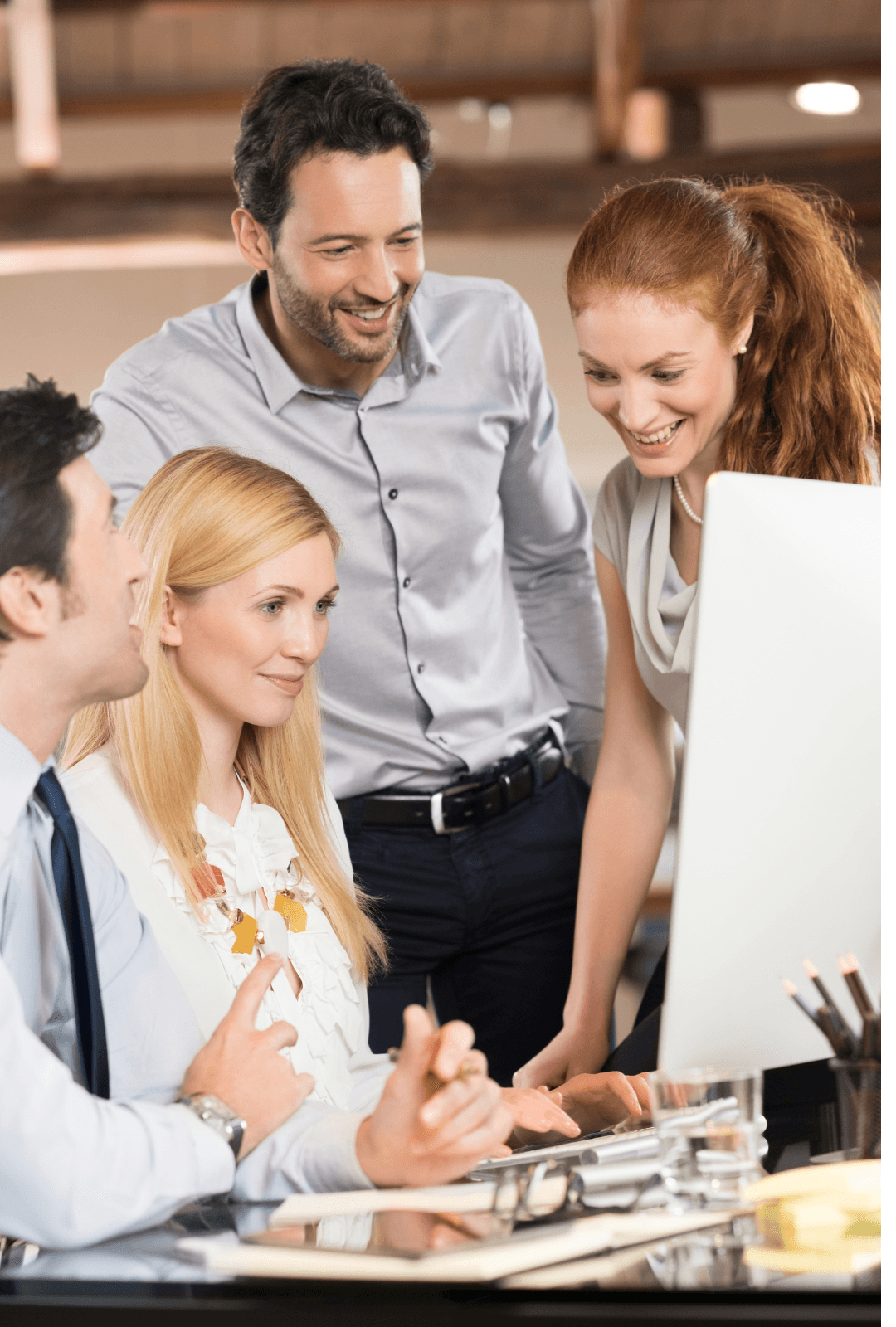 Image of colleagues gathered around a computer
