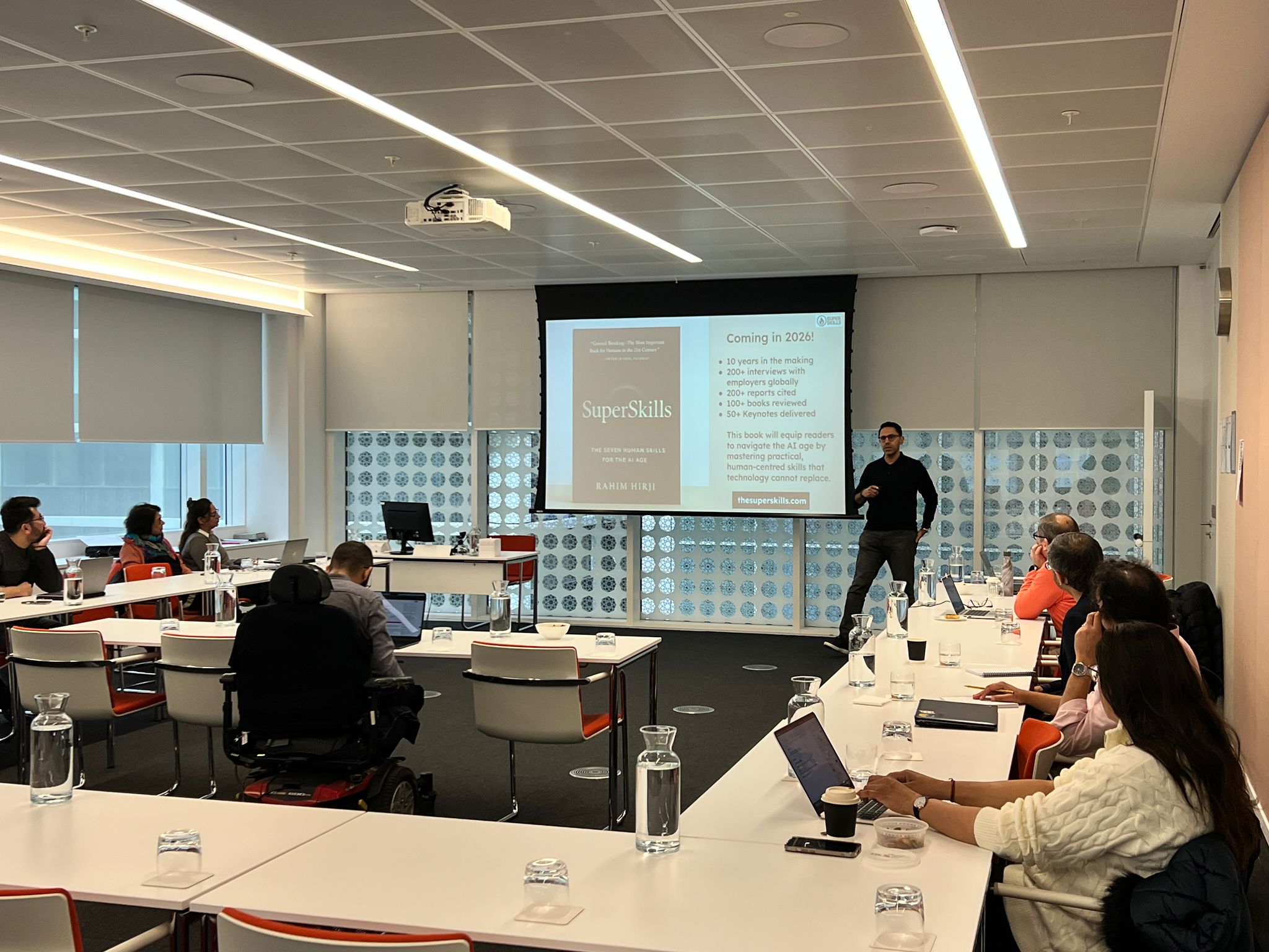 man wearing gray polo shirt beside dry-erase board