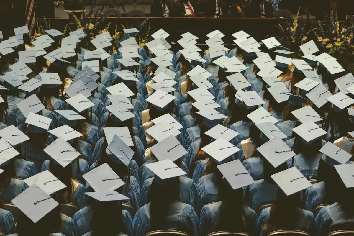 A photo of students at graduation ceremony from the back.