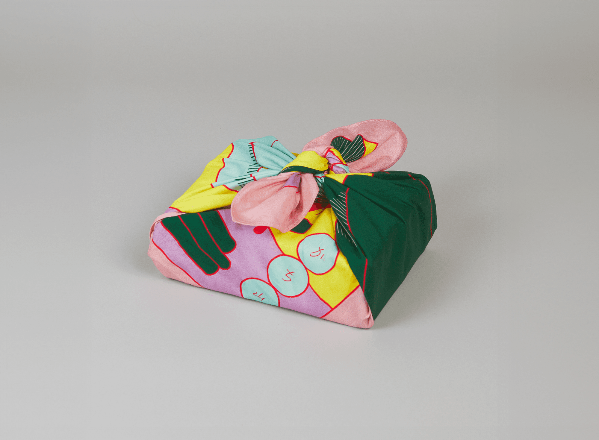 Gift box wrapped in the Wrap a Tale furoshiki showing Josephine Grenier’s colorful folklore-inspired illustration.