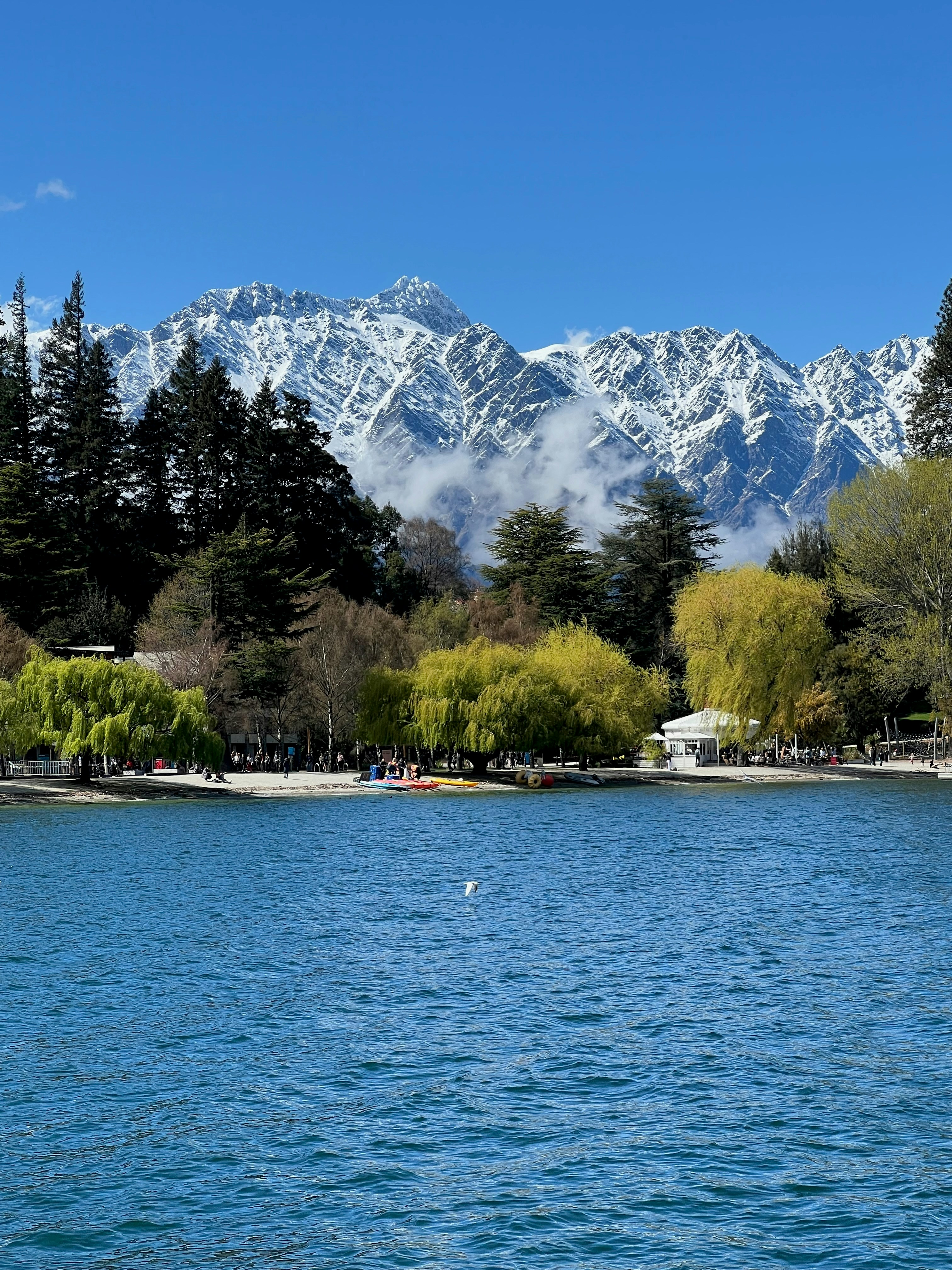 A body of water with mountains in the background