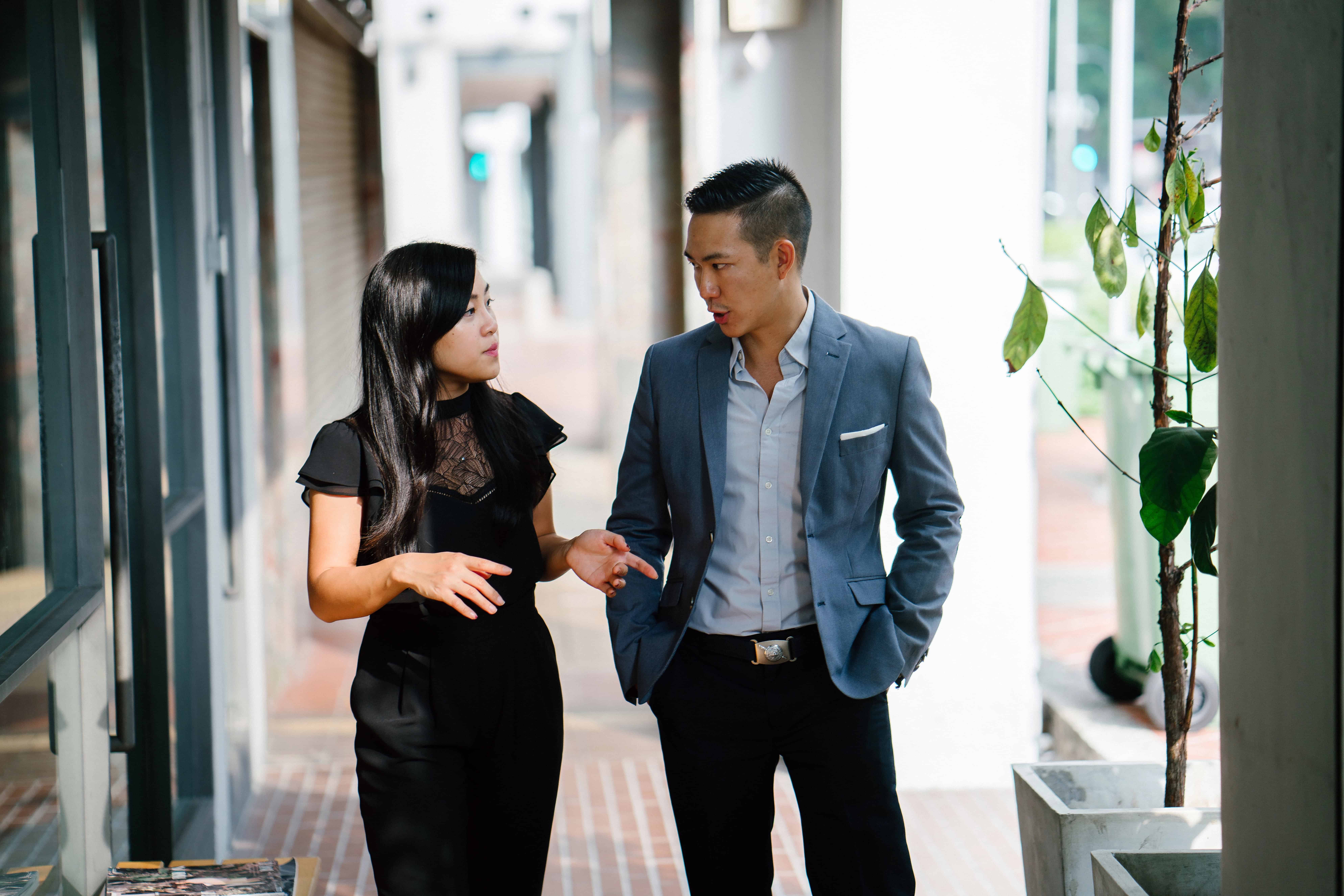 Two Singapore professionals in conversation, discussing workplace mental health and psychosocial risk
