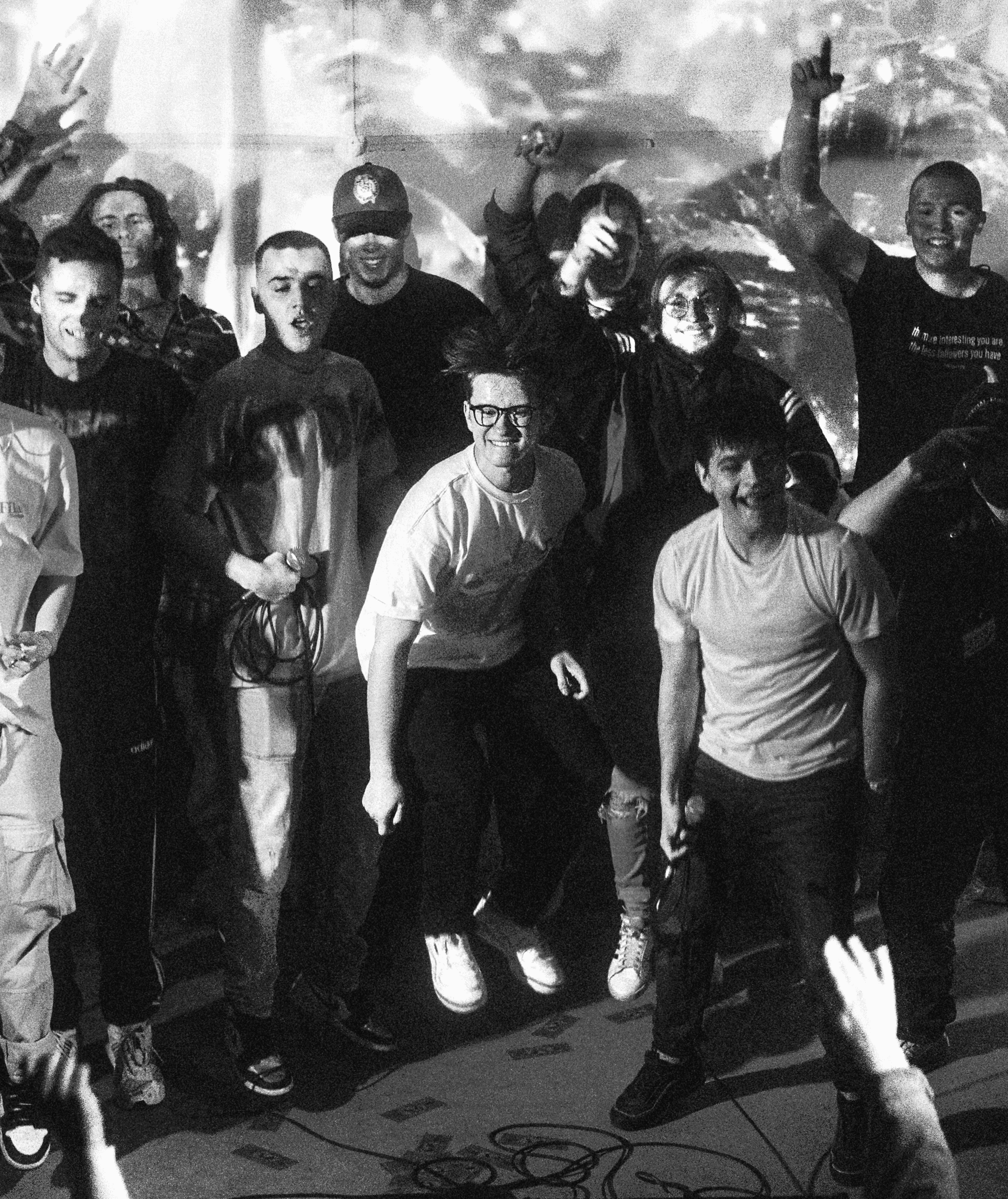 Far shot photo of Bartek's hip hop crew on the scene, jumping to their song.