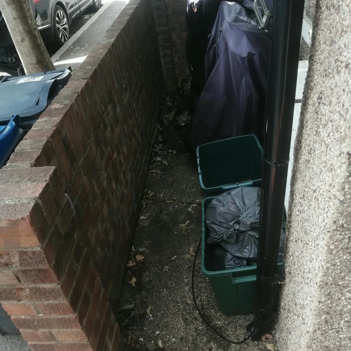 The same Clapham side passage cleared and swept after waste removal