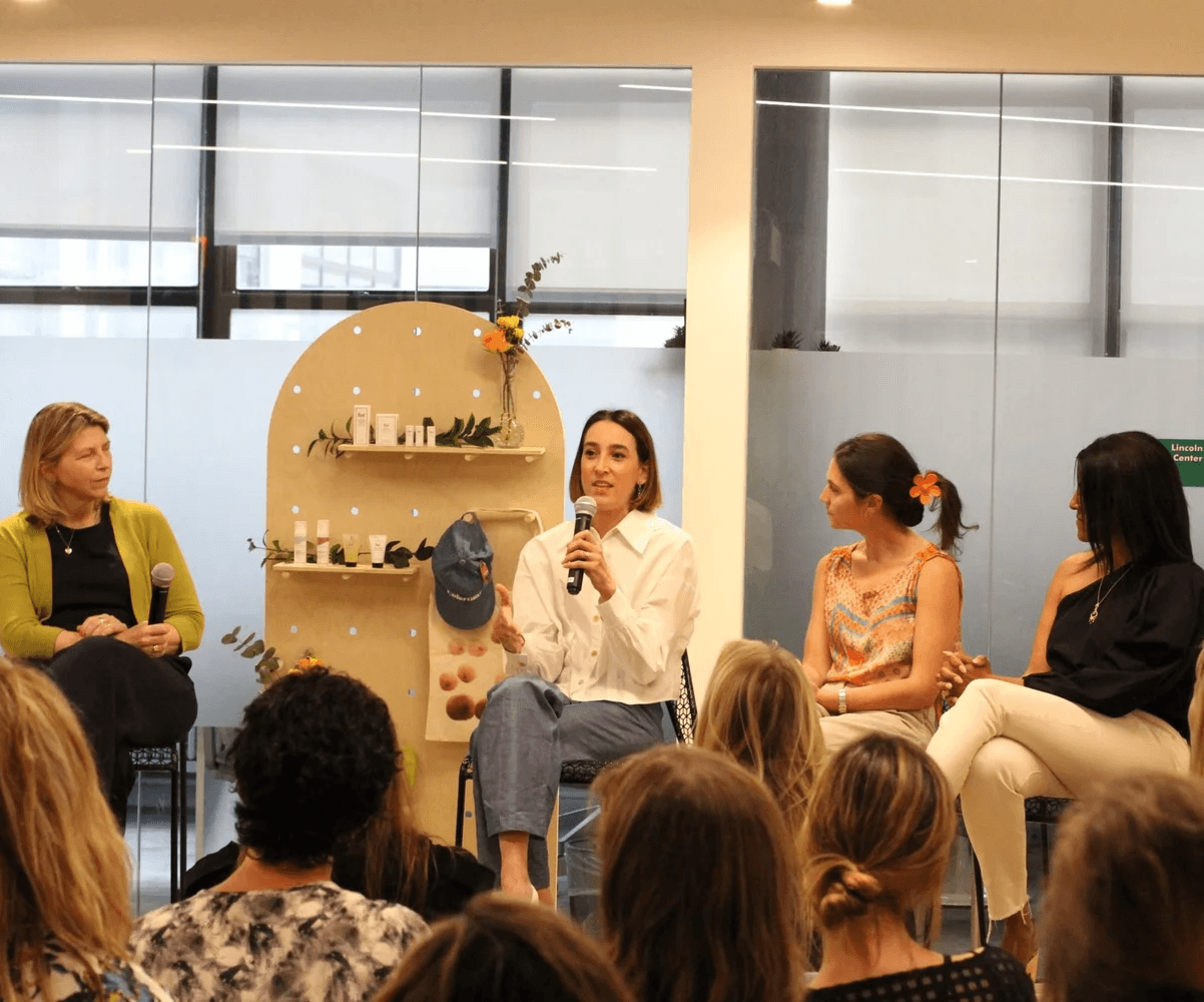 Four women speaking in a well-lit room