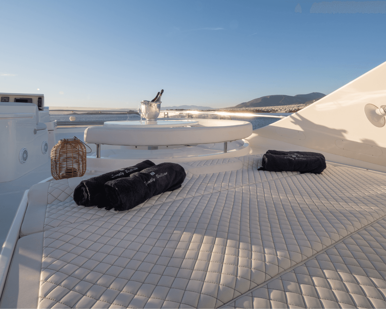 White Rock 36 speedboat with captain at helm cruising calm blue waters near Paros coastline with hills in background.