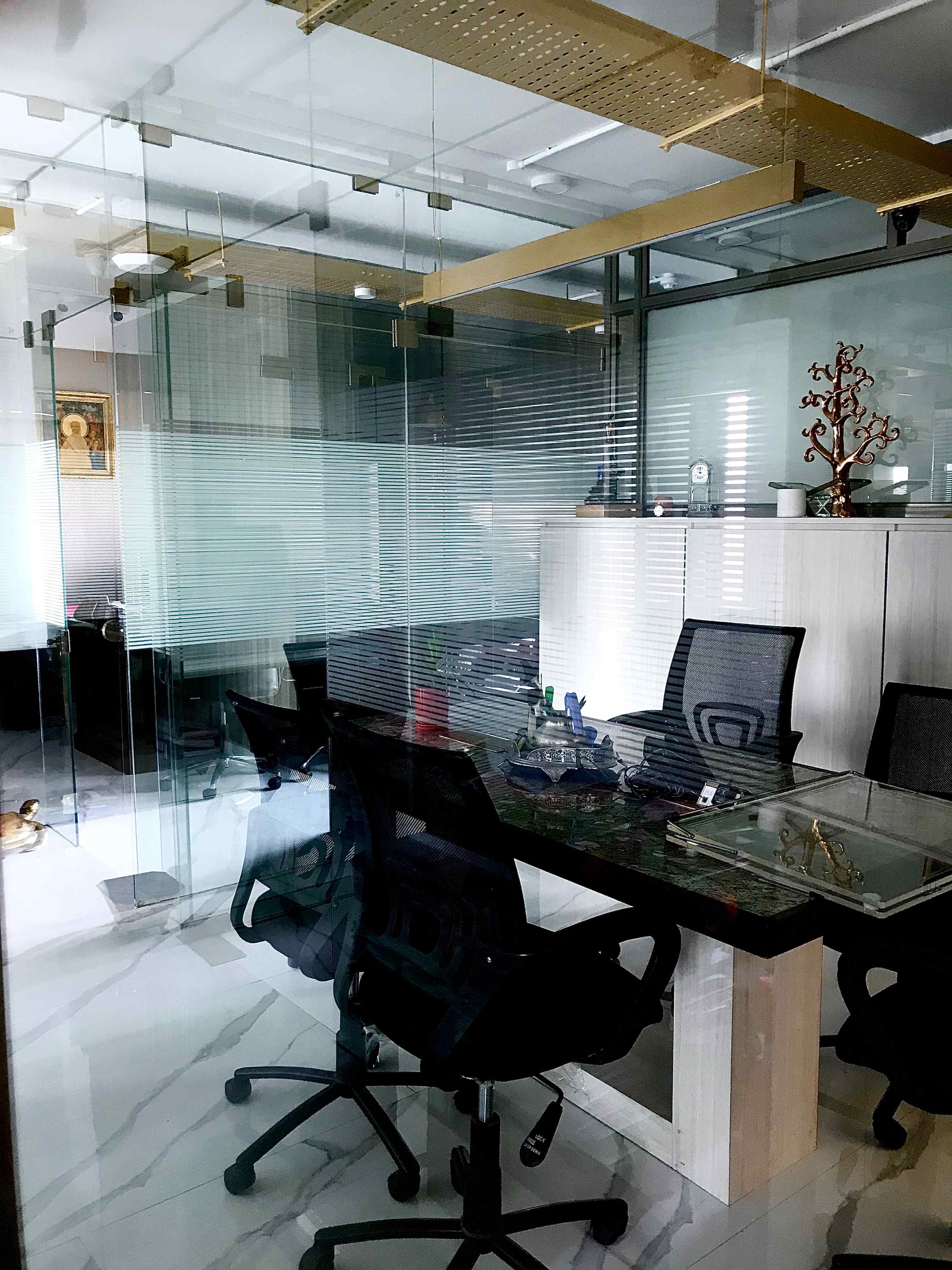 Nature-inspired preschool entrance with sculptural tree partitions and suspended green leaf ceiling panels.