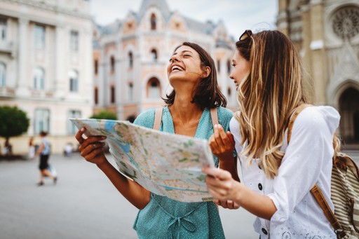 A maroon passport, a credit card, and a document are placed on a dark surface.
