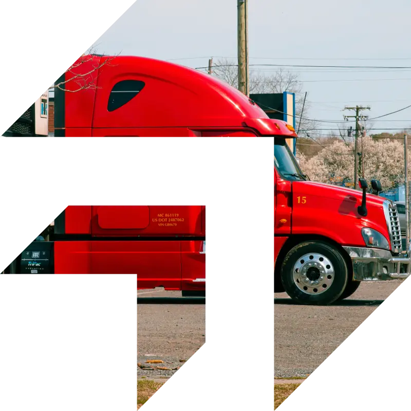 A red semi-truck parked on a lot under clear skies — representing startup trucking businesses preparing to get insured and hit the road with GIA Group, LLC.
