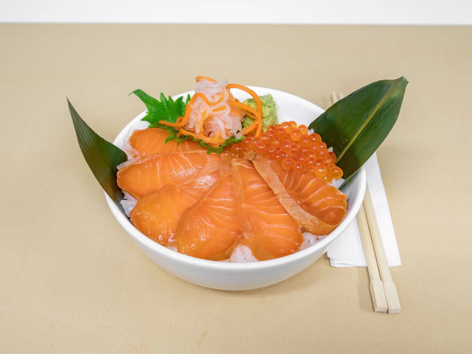 An overhead shot of the Sushi Premium Dinner Set, showcasing an artful arrangement of seasonal nigiri and sashimi. Vibrant slices of fresh fish like salmon, tuna, and yellowtail are placed alongside delicately carved vegetables and a small mound of pickled ginger.