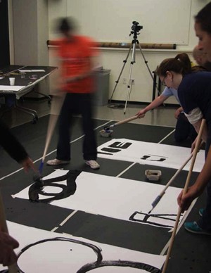 students making art with brushes and ink